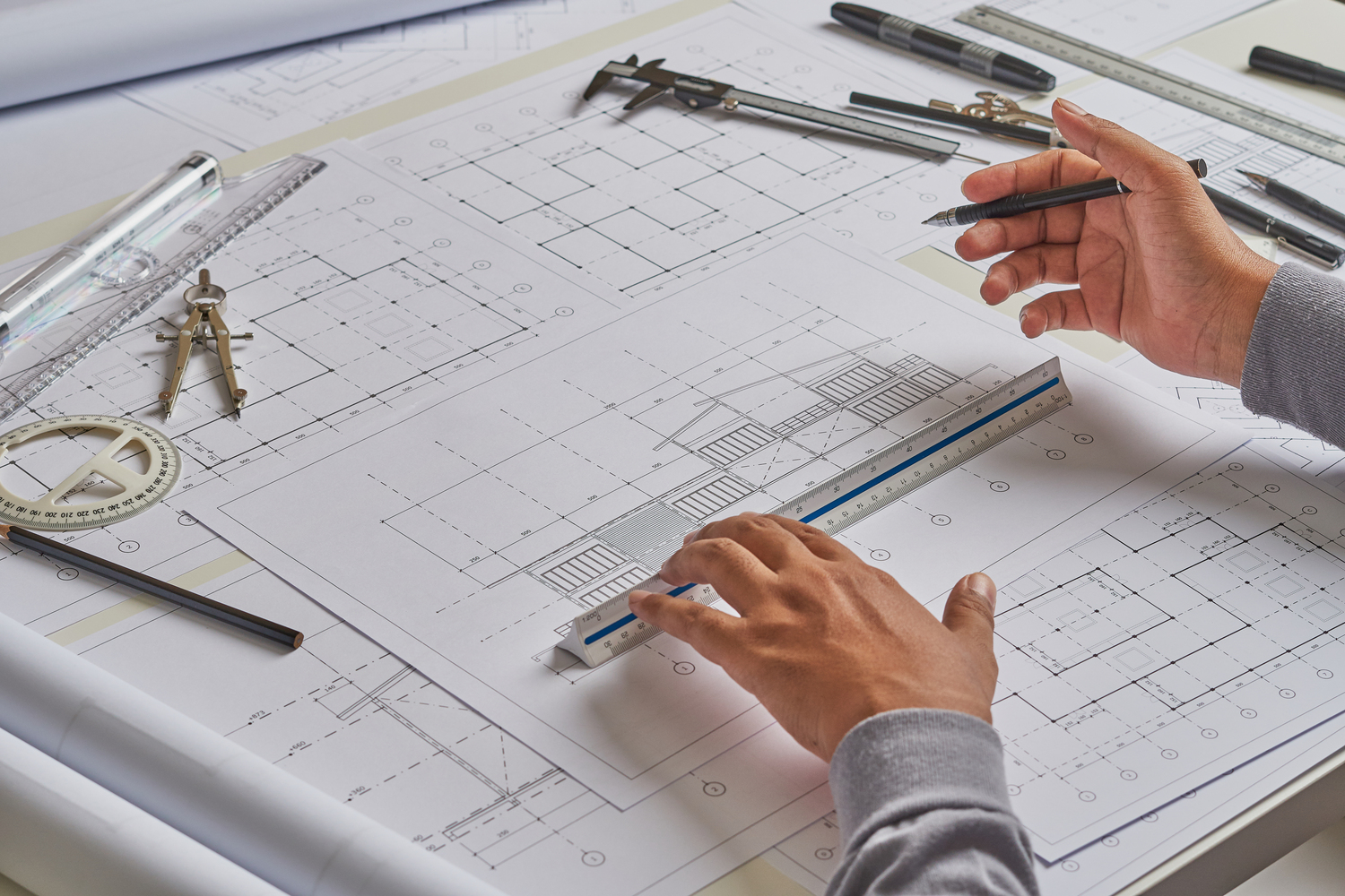 Architect engineer contractor design working drawing sketch plan blueprint and making architectural construction house building in architect studio.